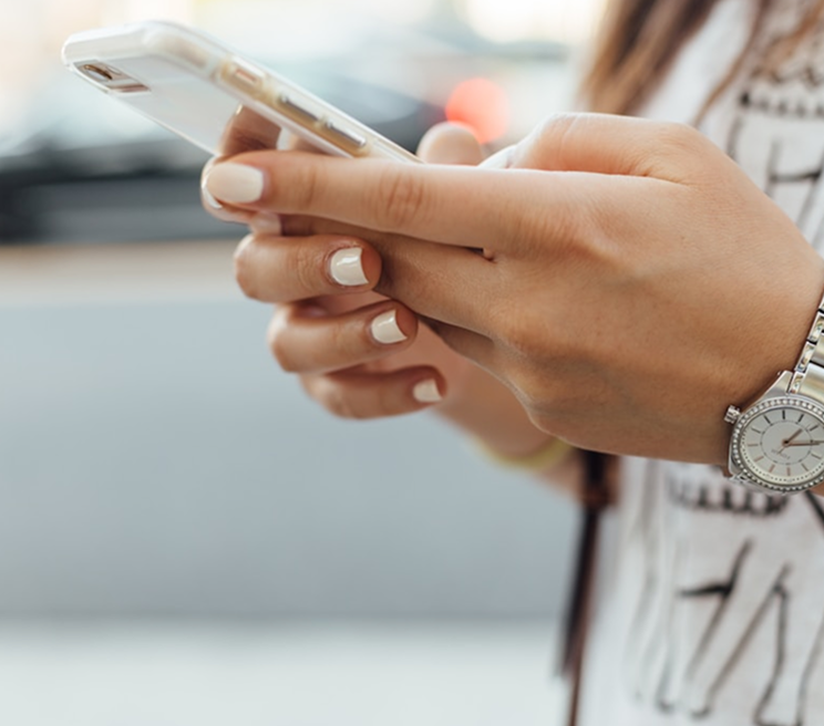 Hände mit einem Smartphone als Sinnbild für die Navigation durch die Inhalte des offiziellen Portals von Roma Capitale